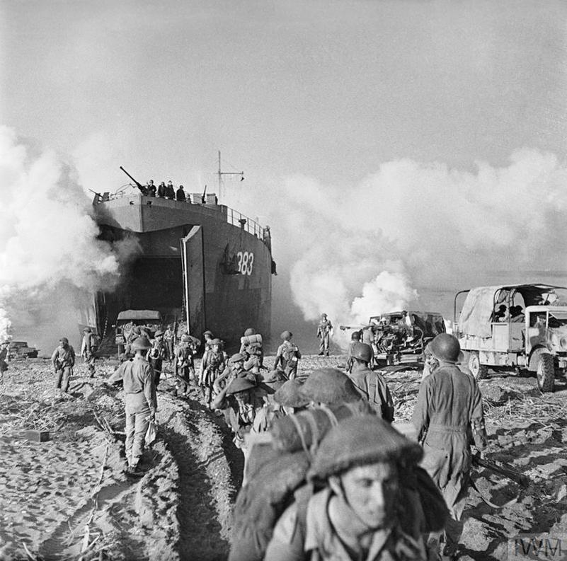 British troops coming ashore with a landing craft in the background at Salerno.