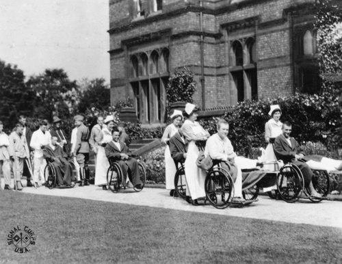 Wounded soldiers being wheeled about the grounds of the American Red Cross Military Hospital