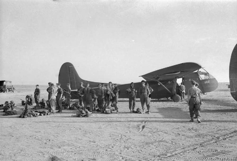 British glider troops stand next to their WACO glider.