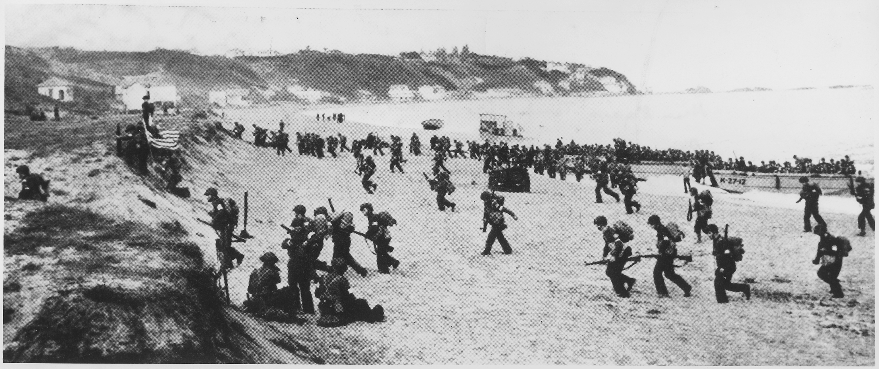 Near Algiers, Torch Troops Hit The Beaches Behind A Large American Flag Left Hoping For Th