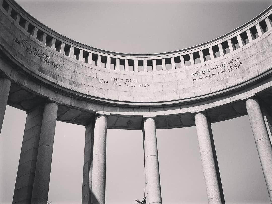Black & white image of pillars of memorial and wording on stonework