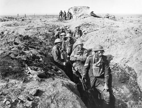 Gas mask-wearing Australian troops in a trench.