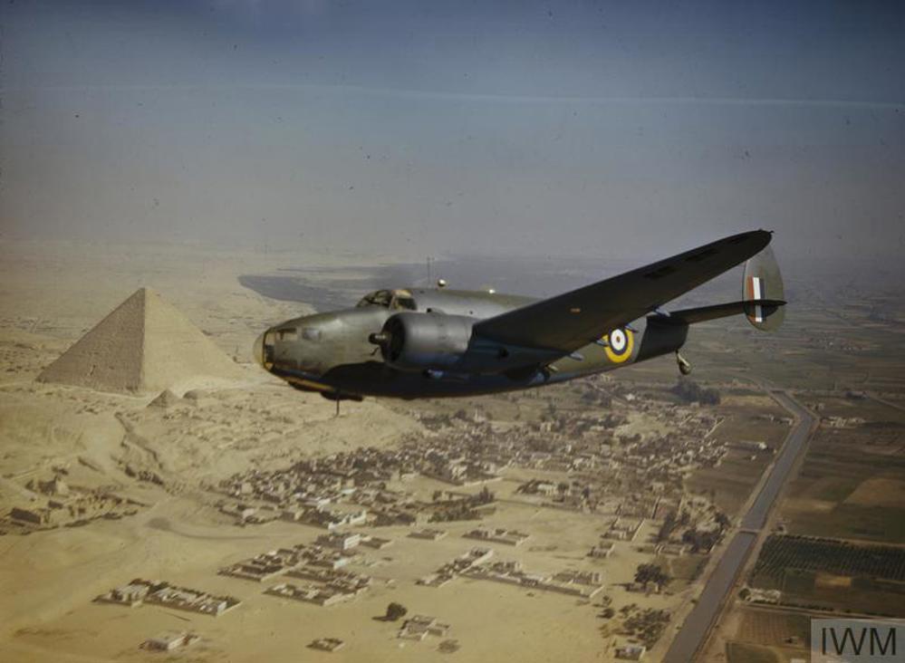 A Royal Air Force Lockheed Hudson Mk VI (AE626) aircraft of the Middle East Communications Flight flying over the pyramids. © IWM (TR 1)