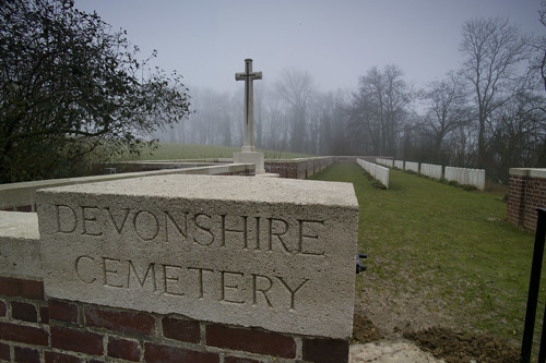 Devonshire Cemetery, Mametz with Cross of Sacrifice and headstone rows visible.
