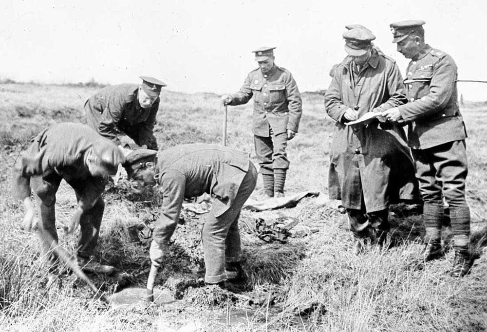 Graves unit out in the field digging a war grave during the First World War.