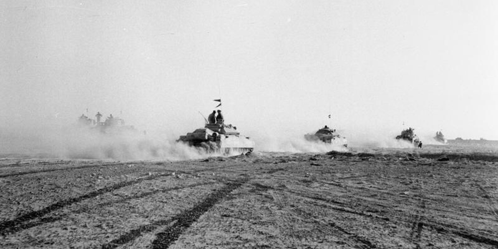 El Alamein 1942: British tanks move up to the battle to engage the German armour after the infantry had cleared gaps in the enemy minefield. © IWM (E 18481)