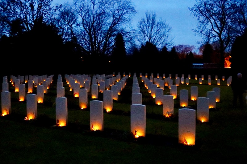 Headstones at Stonefall Cemetery lit by candles