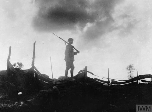 A World War One ANZAC soldier silhouetted against a cloudy sky on the Western Front.