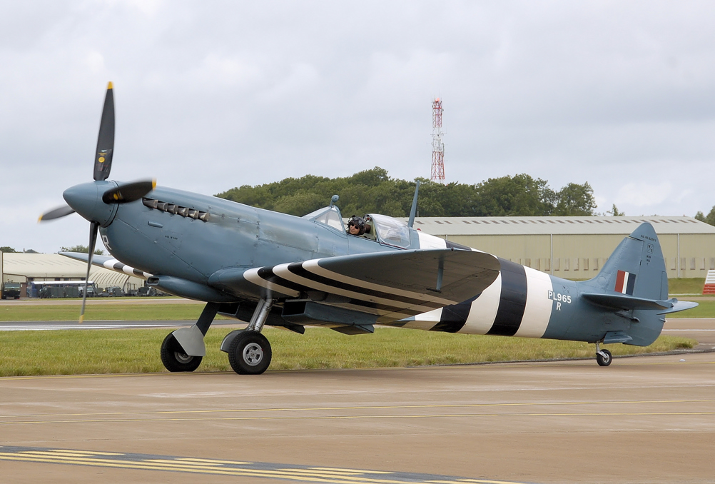 A spitfire painted with invasion stripes and photo recon blue.