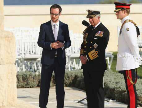 Prince Charles and Prince Harry in military regalia speak to a man in a suit at the Helles Memorial, Gallipoli.