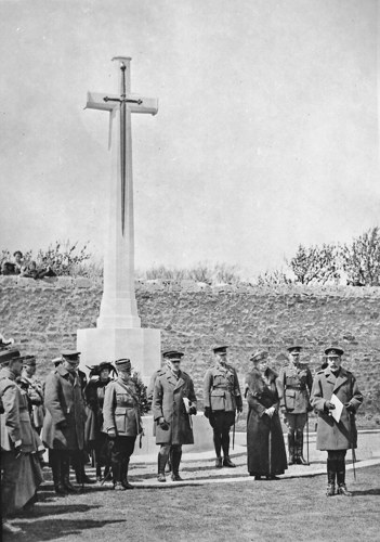 Group standing around a cross of sacrifice