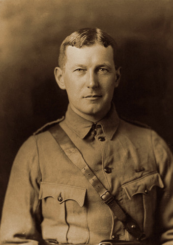 Lt. Colonel John McCrae posing in a sepia-tinted headshot.