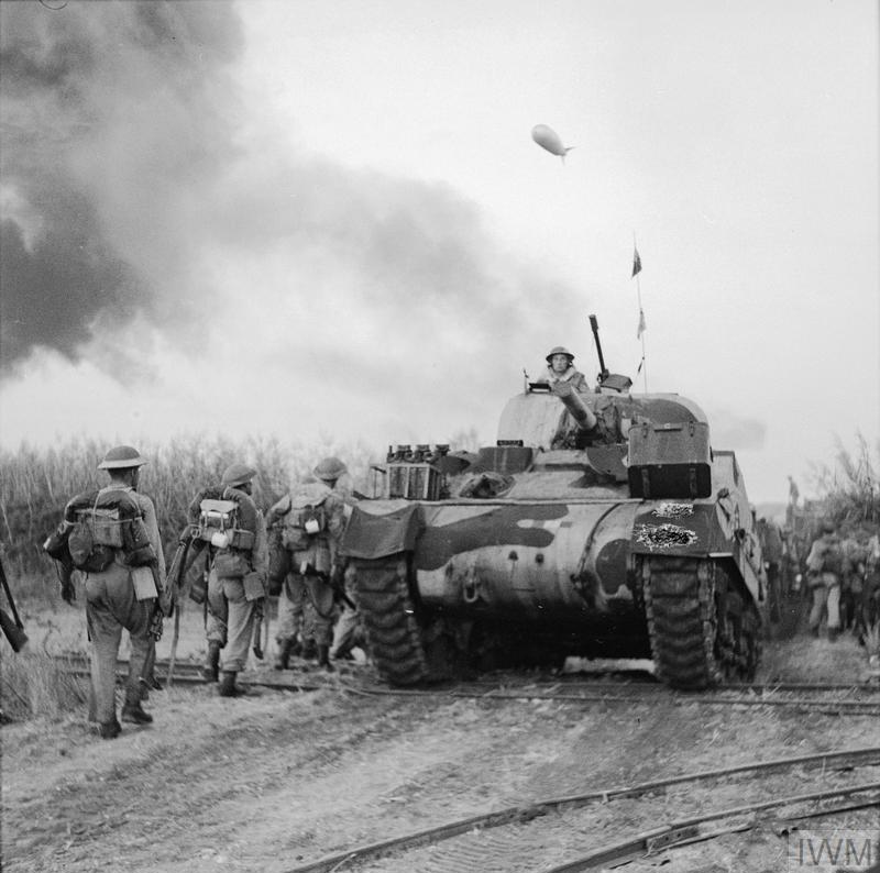 Sherman tank and British Infantry on the move at Salerno, Italy, during WW2.