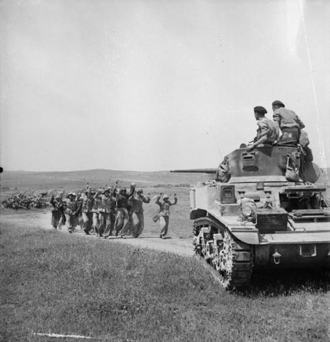German prisoners surrender to a British tank.